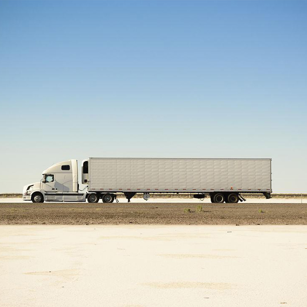 North America truck transportation scene - blue truck on highway